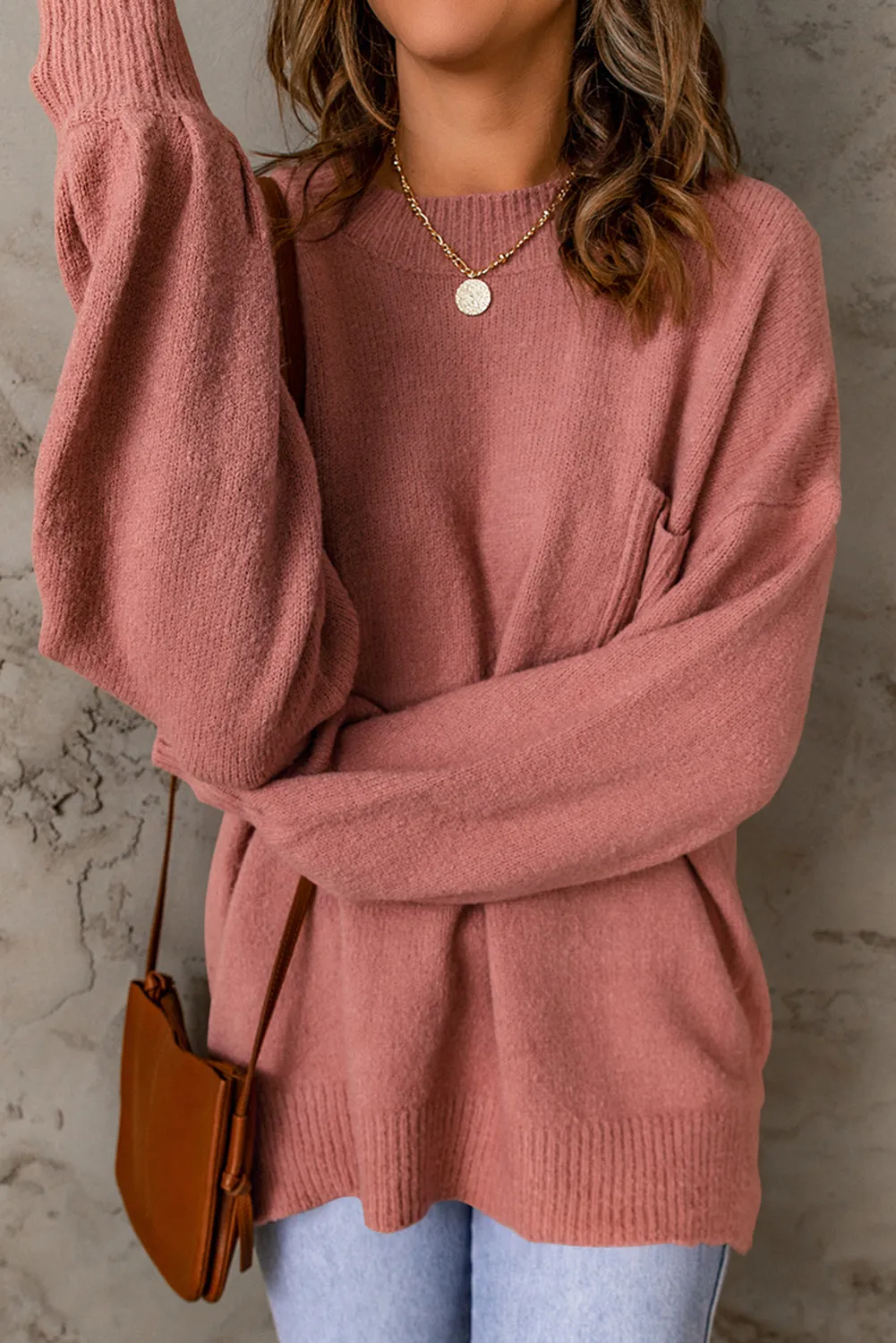 Pull avec poche à manches bouffantes de couleur unie